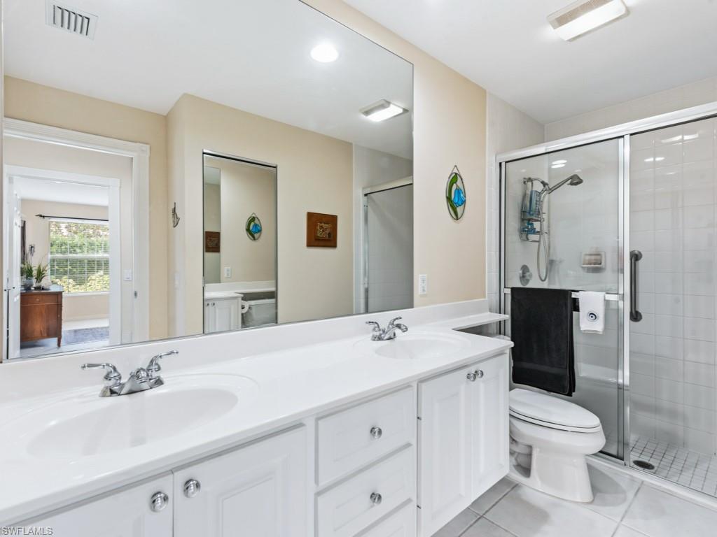 7520 Firenze Lane Naples, FL 34114 - Photo 14 of 32 a bathroom with a granite countertop sink toilet and shower