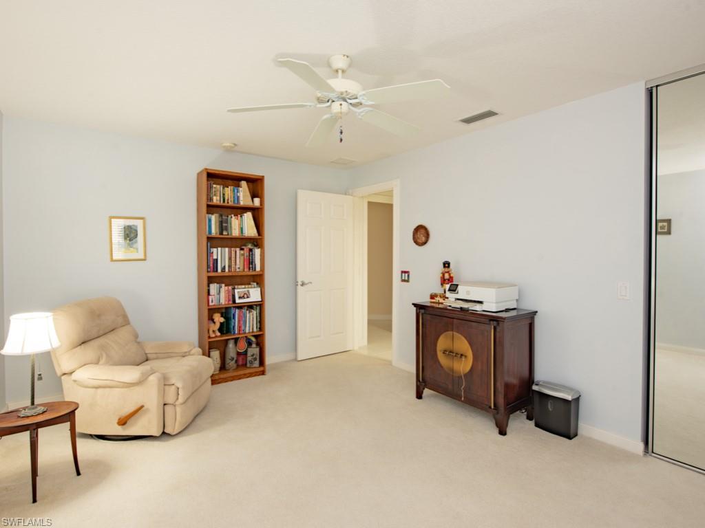 7520 Firenze Lane Naples, FL 34114 - Photo 15 of 32 a living room with furniture and a chandelier