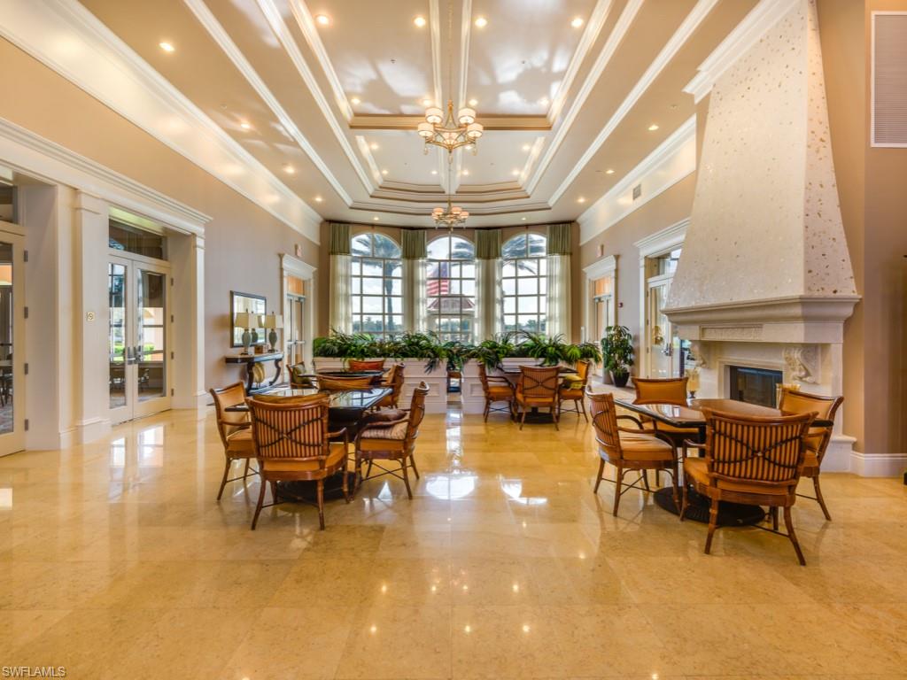 7520 Firenze Lane Naples, FL 34114 - Photo 27 of 32 a view of a dining room with furniture a chandelier and a large window