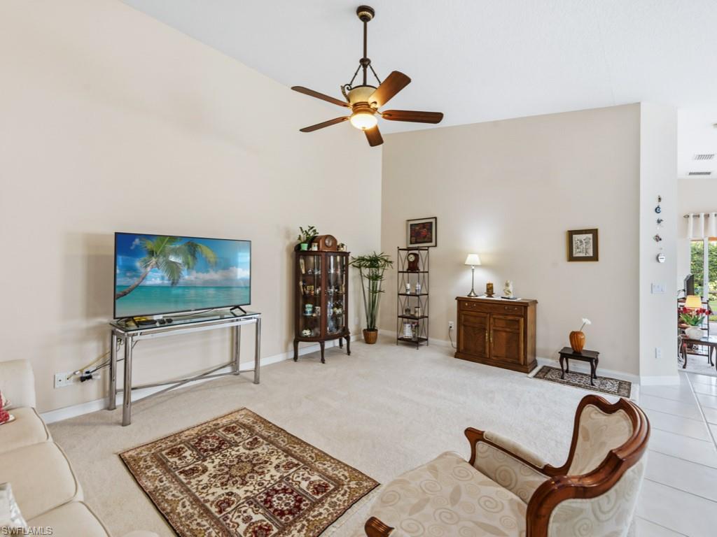 7520 Firenze Lane Naples, FL 34114 - Photo 6 of 32 a living room with furniture and a flat screen tv