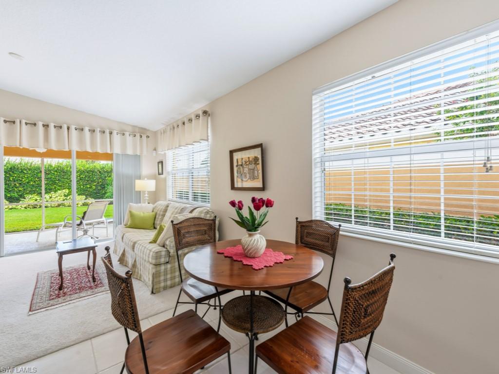 7520 Firenze Lane Naples, FL 34114 - Photo 8 of 32 a view of a dining room with furniture large windows and a livingroom