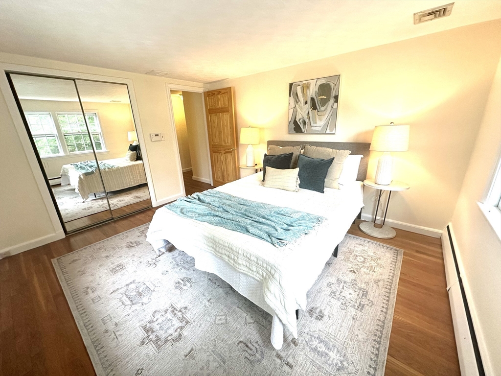 34 Ridgewood Road Westwood, MA 02090 - Photo 15 of 31 a bedroom with a bed and wooden floor