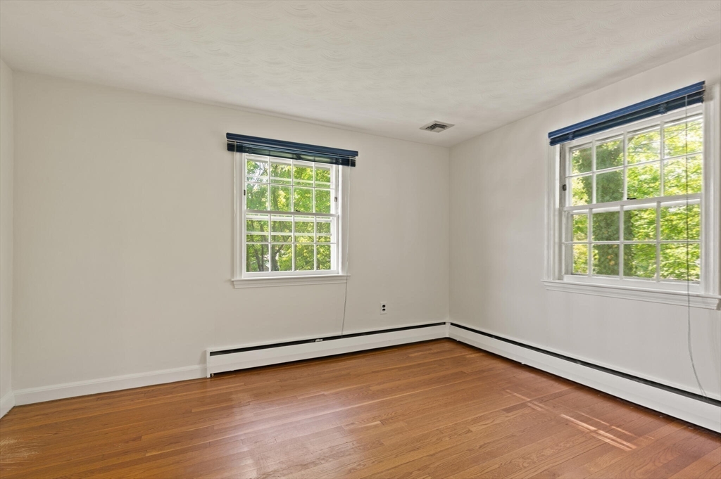 34 Ridgewood Road Westwood, MA 02090 - Photo 17 of 31 a view of an empty room with wooden floor and a window