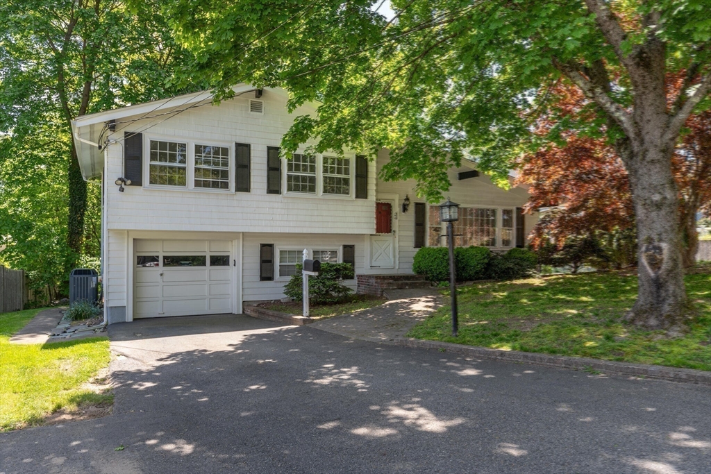 34 Ridgewood Road Westwood, MA 02090 - Photo 31 of 31 a front view of a house with a yard and garage