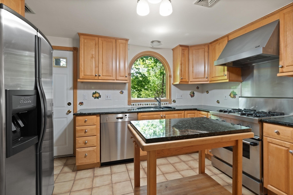 34 Ridgewood Road Westwood, MA 02090 - Photo 8 of 31 a kitchen with stainless steel appliances granite countertop a stove refrigerator sink and cabinets