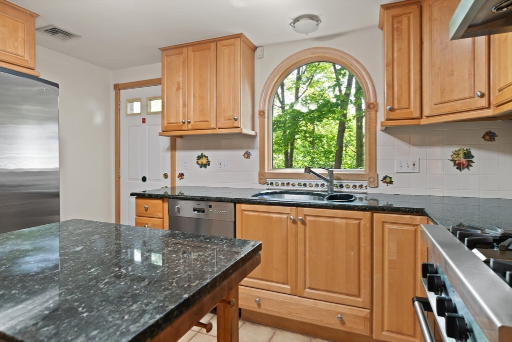 34 Ridgewood Road Westwood, MA 02090 - Photo 9 of 31 a kitchen with stainless steel appliances granite countertop a stove a sink dishwasher and cabinets with wooden floor