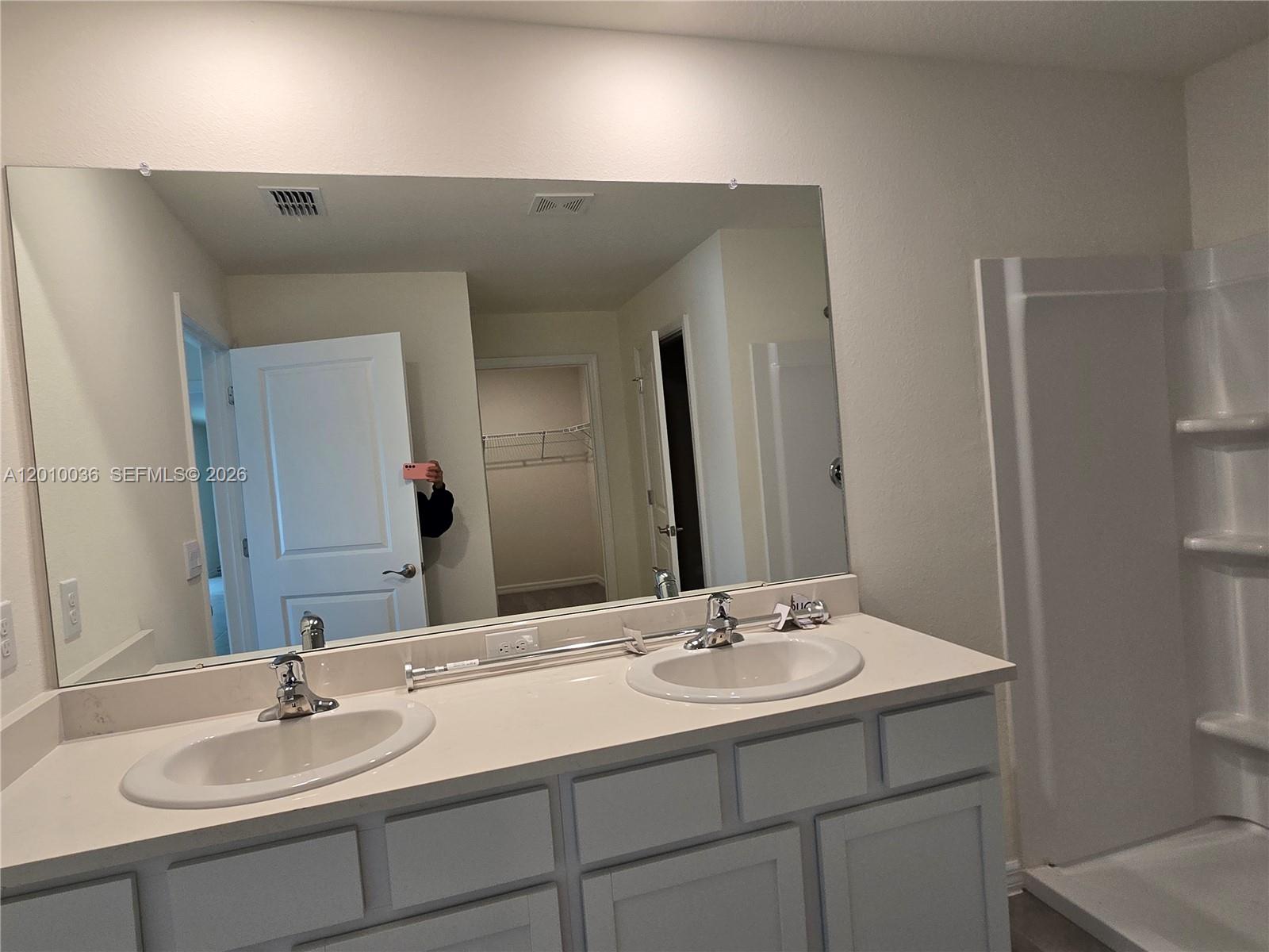 9871 Southeast 161st Lane Road Summerfield, FL 34491 - Photo 18 of 31 a bathroom with a sink and a mirror