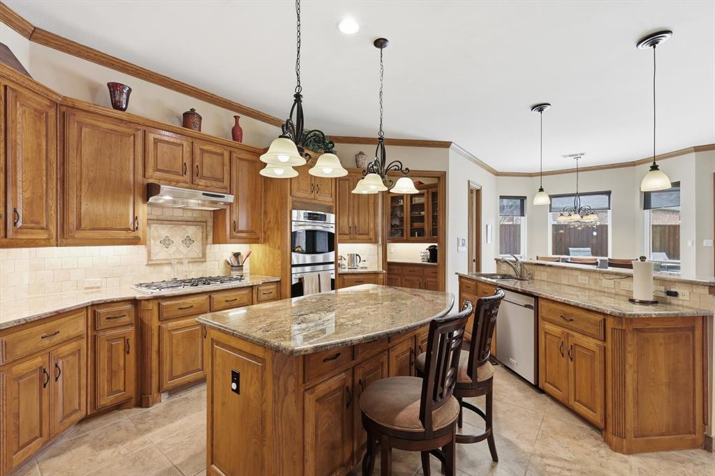 3413 Lantz Circle Plano, TX 75025 - Photo 11 of 38 a kitchen with center island table and chairs