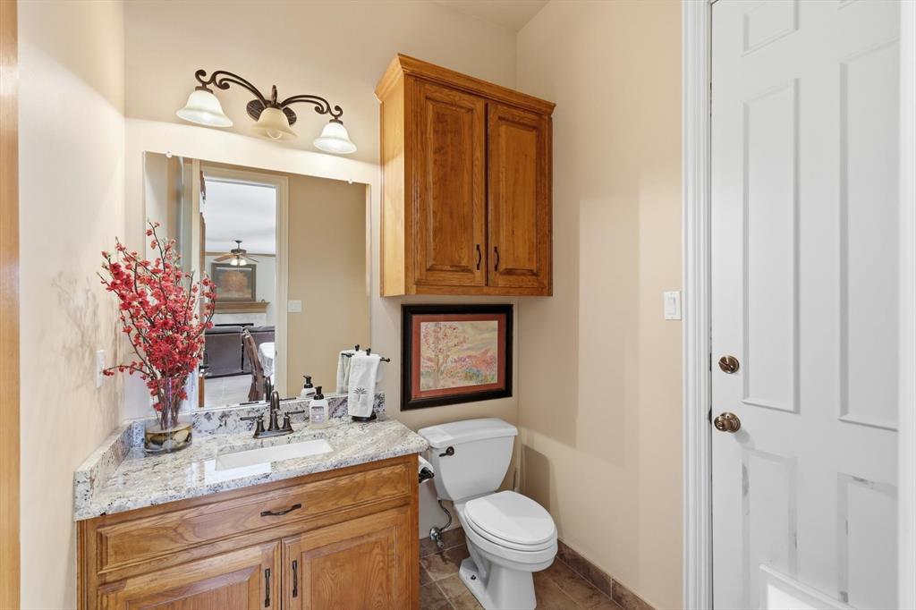 3413 Lantz Circle Plano, TX 75025 - Photo 13 of 38 a bathroom with a granite countertop toilet sink and mirror