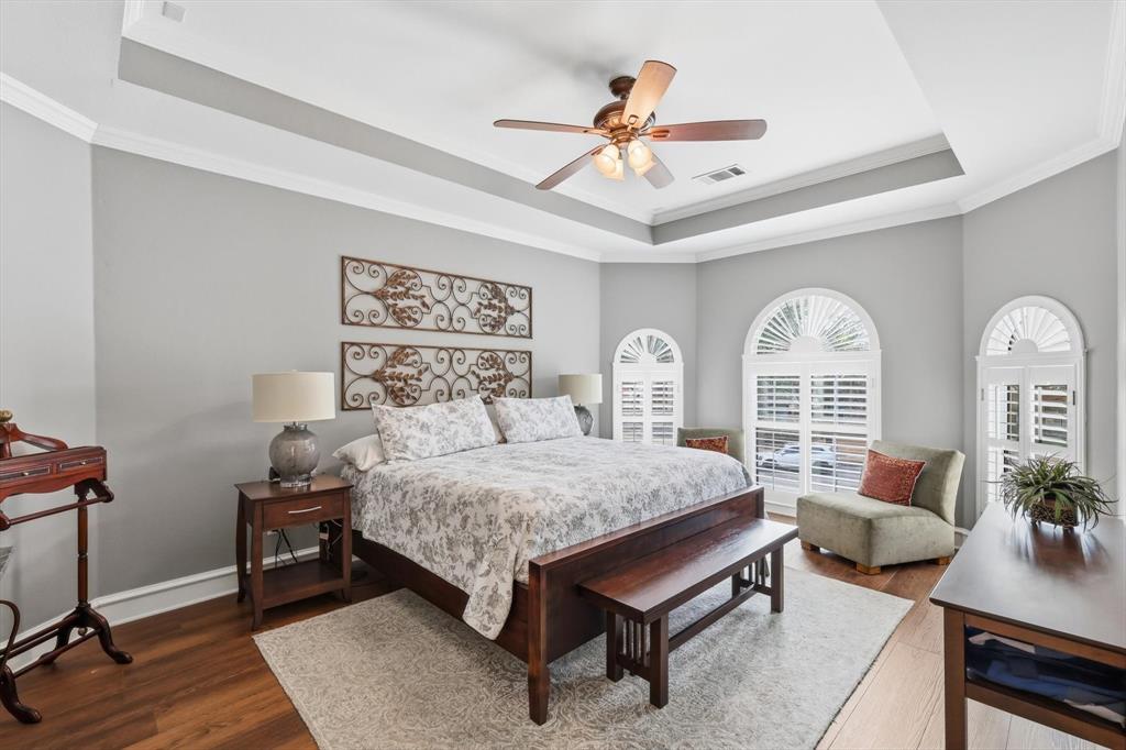 3413 Lantz Circle Plano, TX 75025 - Photo 23 of 38 a bedroom with a bed a chandelier and a dresser