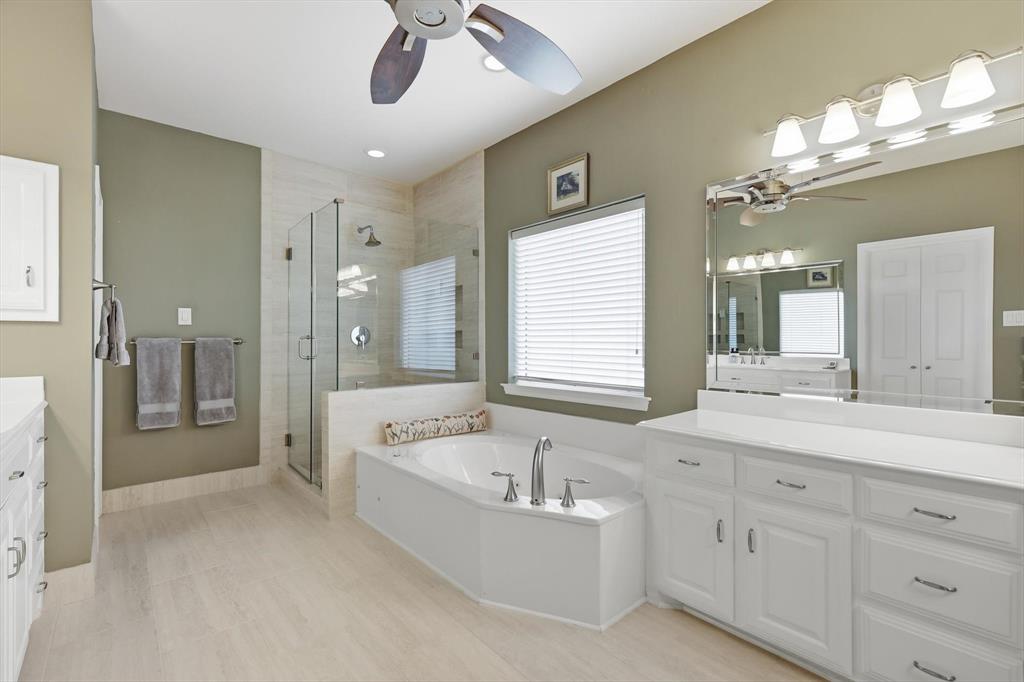 3413 Lantz Circle Plano, TX 75025 - Photo 24 of 38 a spacious bathroom with a granite countertop tub shower double sink and mirror