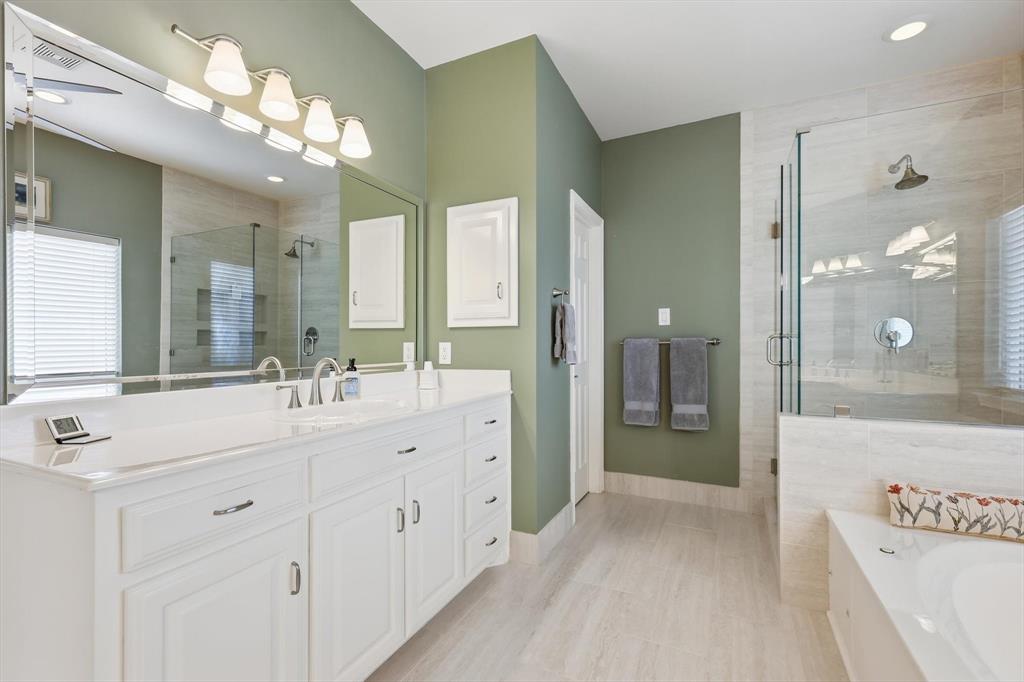 3413 Lantz Circle Plano, TX 75025 - Photo 26 of 38 a spacious bathroom with a shower a sink and a mirror