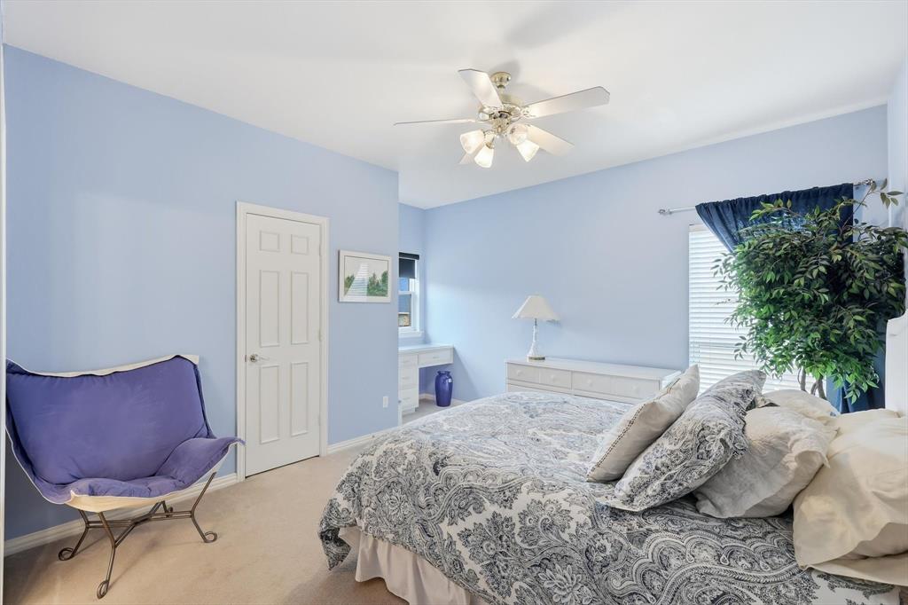 3413 Lantz Circle Plano, TX 75025 - Photo 27 of 38 a bedroom with a bed a chandelier and a chair