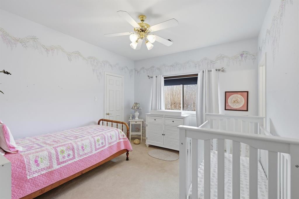3413 Lantz Circle Plano, TX 75025 - Photo 29 of 38 a bedroom with a bed and a chandelier