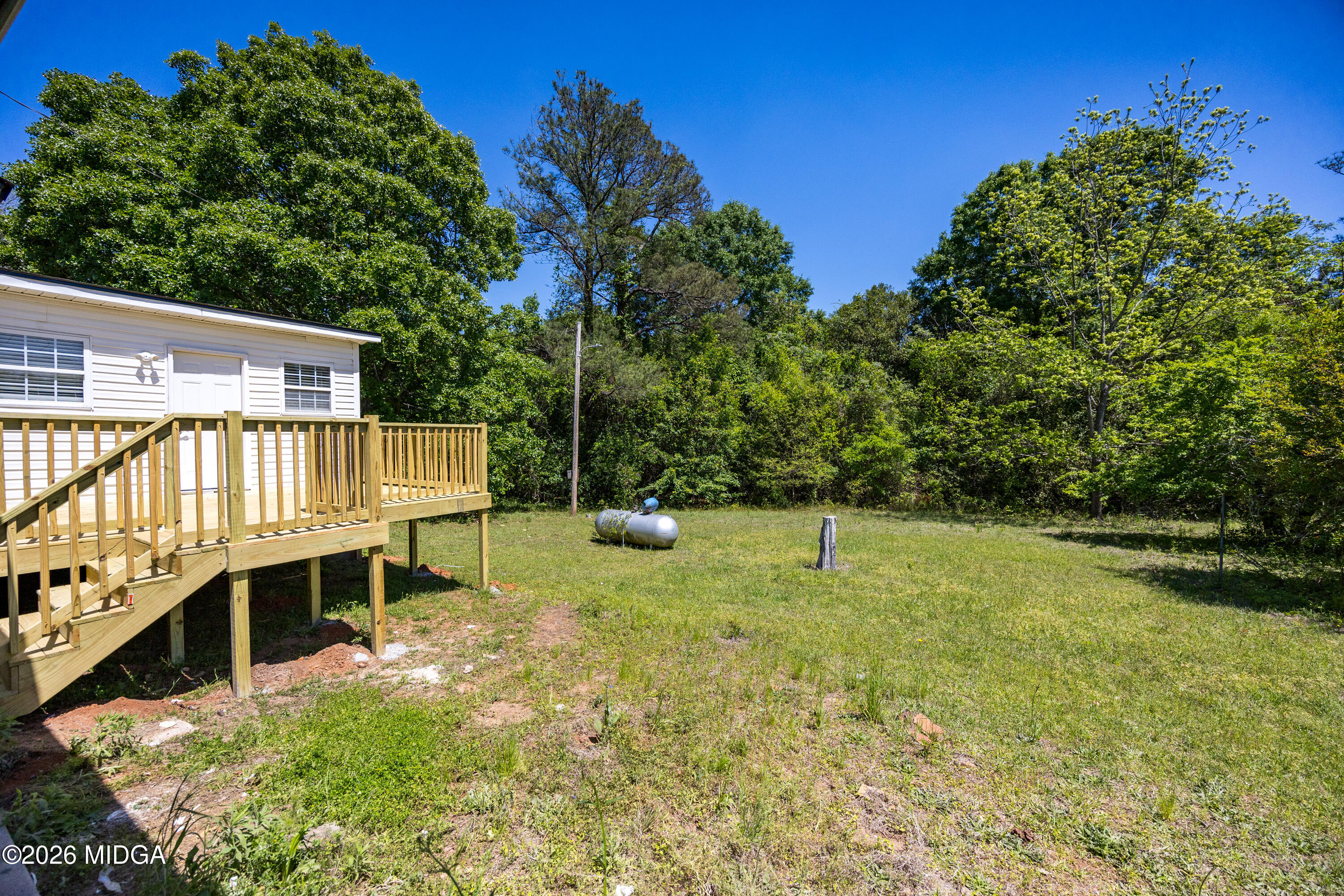 427 Gun Club Road Fort Valley, GA 31030 - Photo 24 of 26 a backyard of a house with yard and outdoor seating