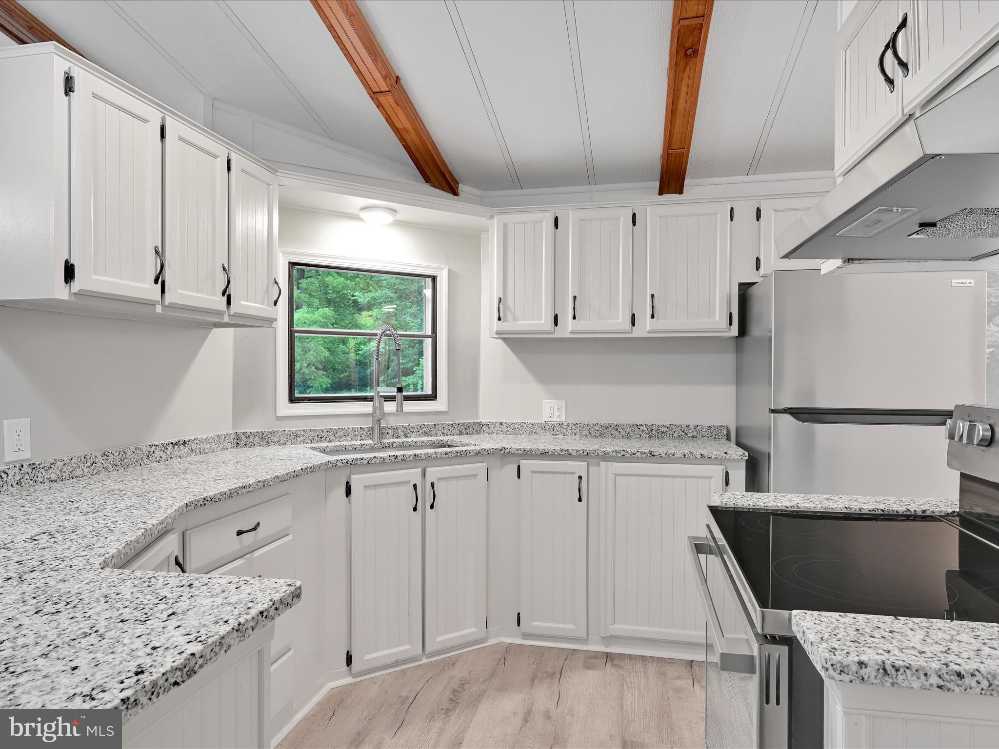 207 Mill Creek Road Kutztown, PA 19530 - Photo 6 of 26 a kitchen with granite countertop a sink window and cabinets