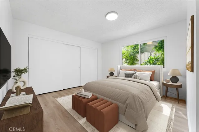 a room with a bed and a potted plant