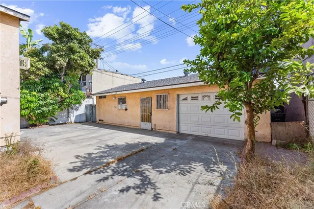 a view of a house with a tree in front of it