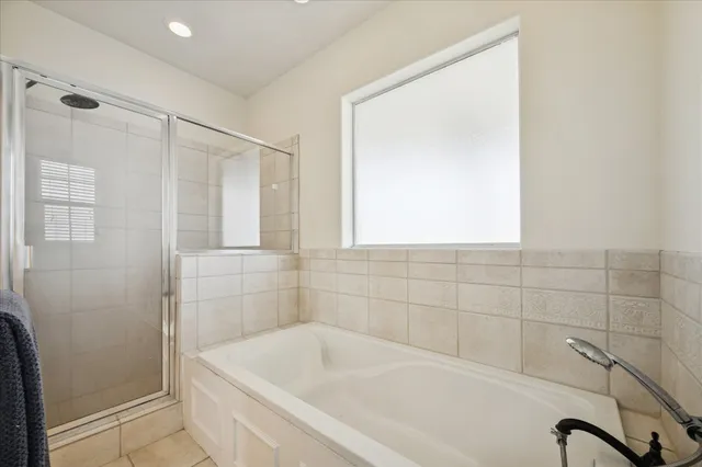 a bathroom with a bathtub and shower