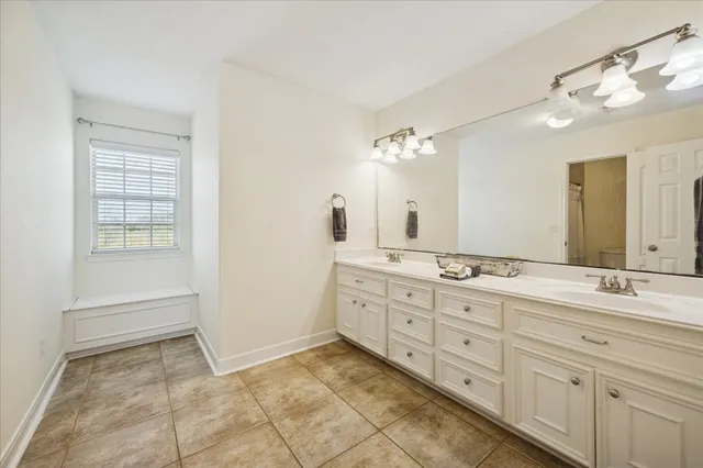 a spacious bathroom with a granite countertop sink a mirror and a