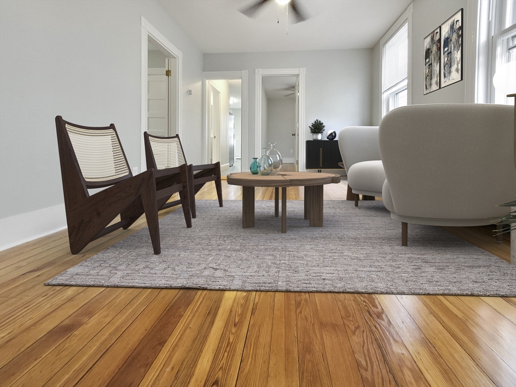 44 Guild Street, Unit 2 Boston, MA 02119 - Photo 3 of 8 a living room with furniture and a couch