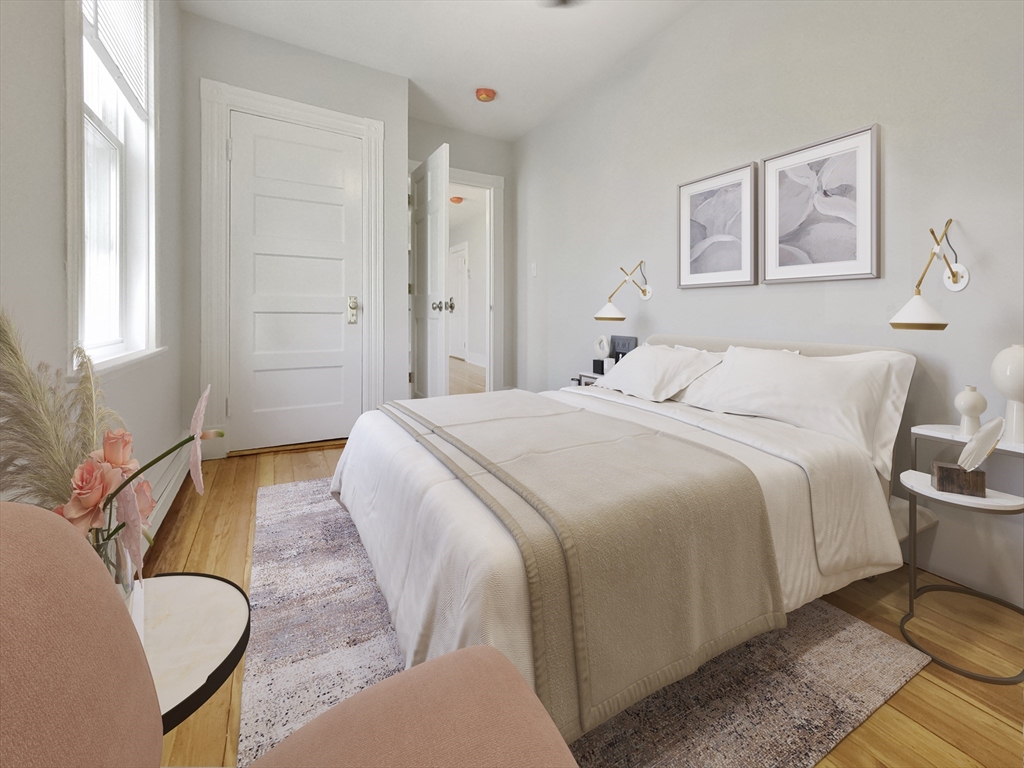 44 Guild Street, Unit 2 Boston, MA 02119 - Photo 5 of 8 a bedroom with a bed couch and window
