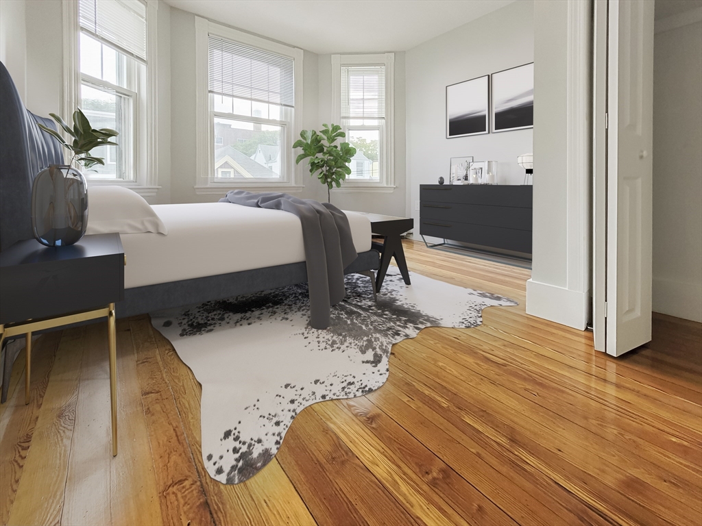 44 Guild Street, Unit 2 Boston, MA 02119 - Photo 6 of 8 a bedroom with a bed wooden floor and window