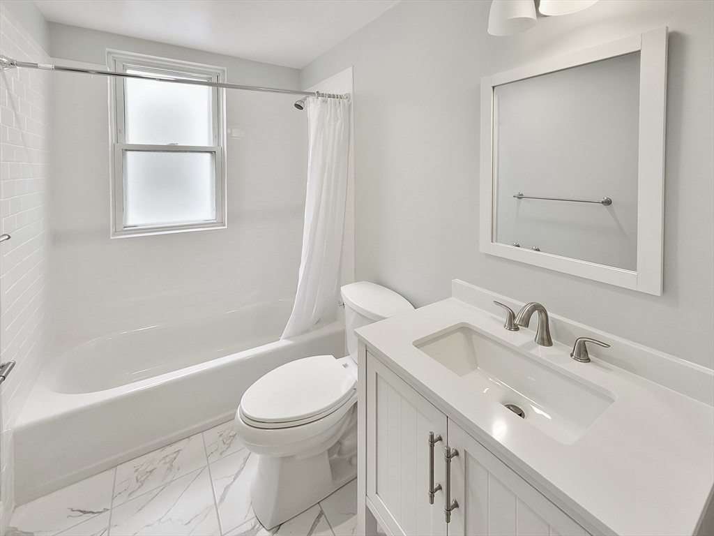 44 Guild Street, Unit 2 Boston, MA 02119 - Photo 8 of 8 a bathroom with a sink toilet and shower