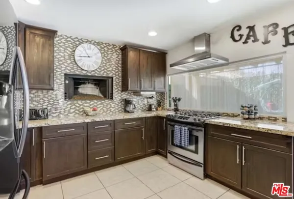 a kitchen with stainless steel appliances granite countertop a stove and a sink