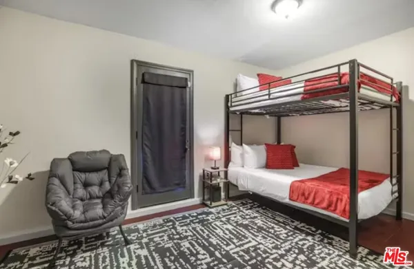 a bedroom with furniture and a rug