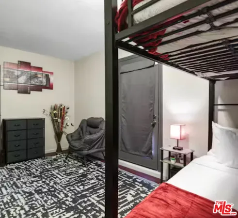 a bedroom with a bed and cabinets