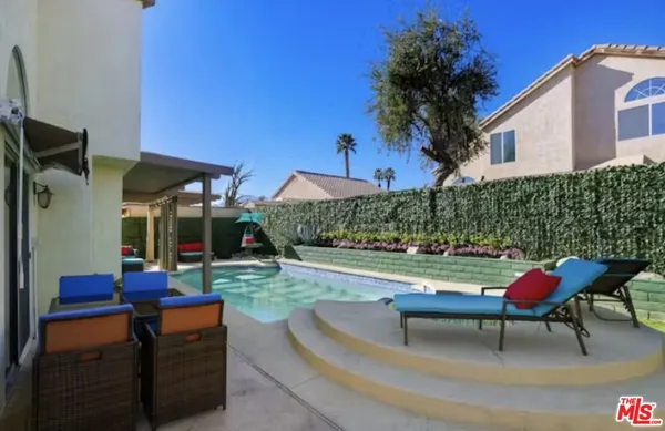a backyard of a house with outdoor seating