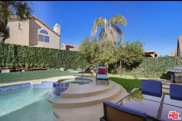 a view of a chairs and table in the yard