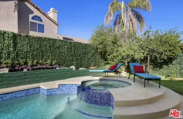 a house view with a sitting space and garden