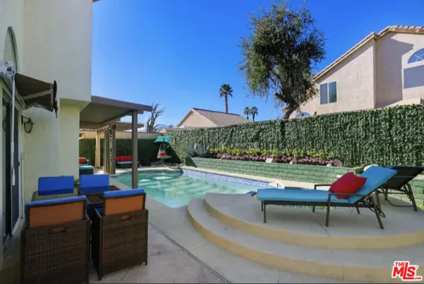 a backyard of a house with outdoor seating