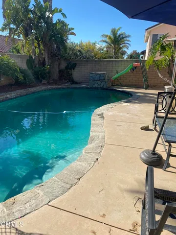 a view of a swimming pool with a patio