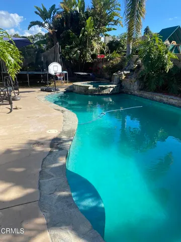 a view of a backyard with table and chairs