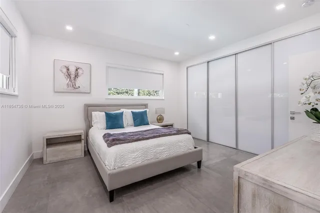 a spacious bedroom with a bed and a table