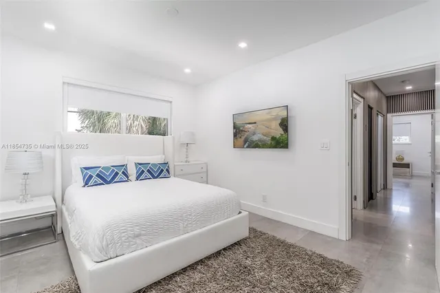 a bedroom with a bed and a painting