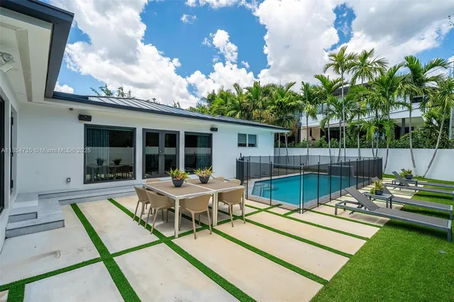 a view of a house with backyard sitting area and garden