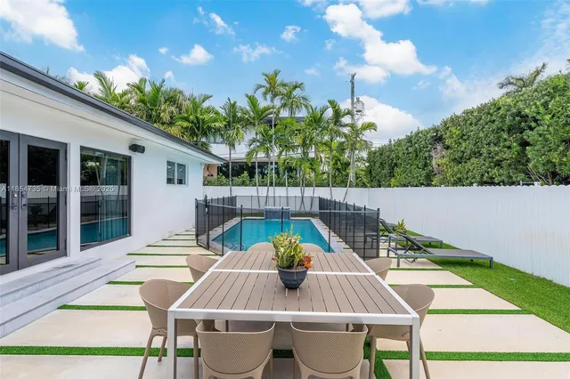 a view of table and chair with potted plants
