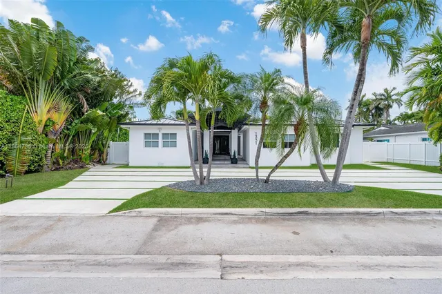 a lobby with a potted plant and a table