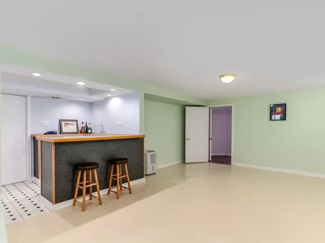 a view of a room with wooden floor and cabinets