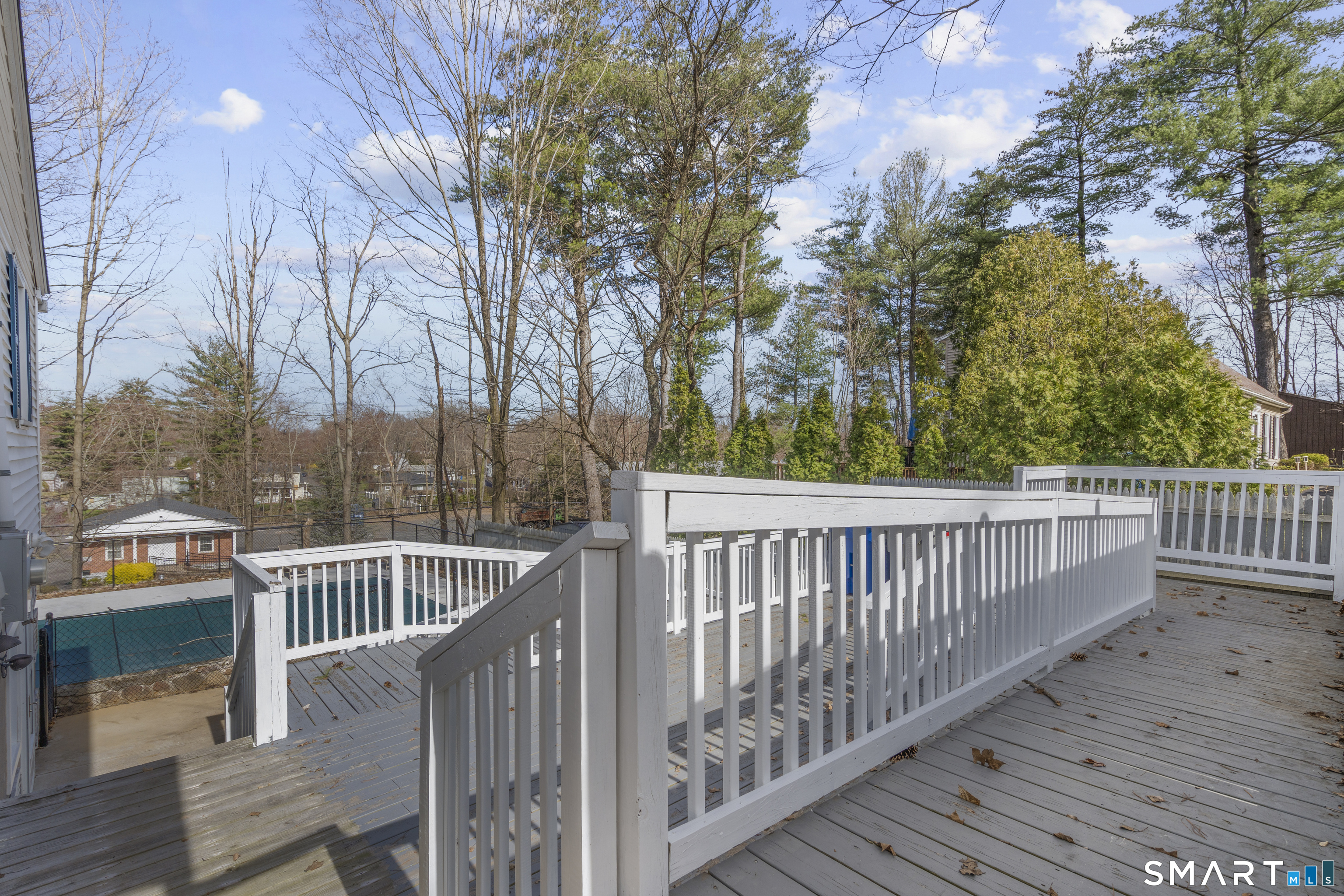9 Daniel Road, Unit 9B Bristol, CT 06010 - Photo 14 of 16 a view of a deck with wooden floor and fence with a bench