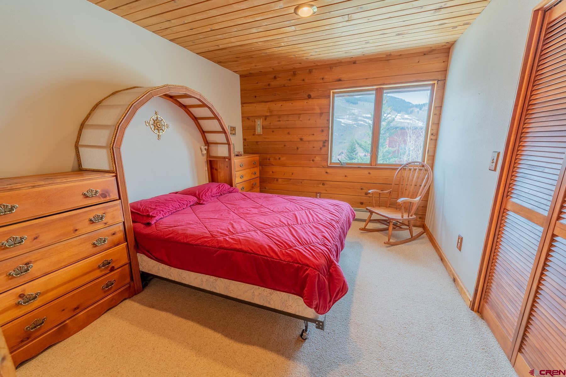 10 Arrowhead Circle Crested Butte, CO 81225 - Photo 16 of 33 a bed sitting in a bedroom next to a window