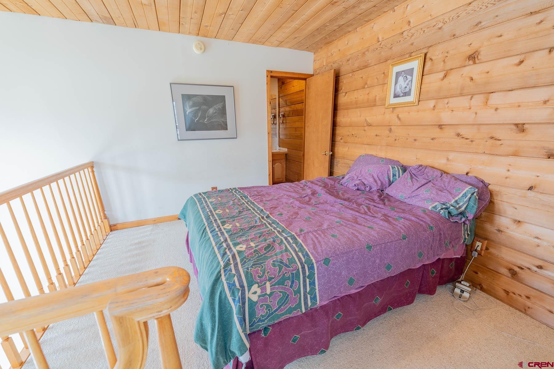 10 Arrowhead Circle Crested Butte, CO 81225 - Photo 20 of 33 a bedroom with a bed and a wall painting