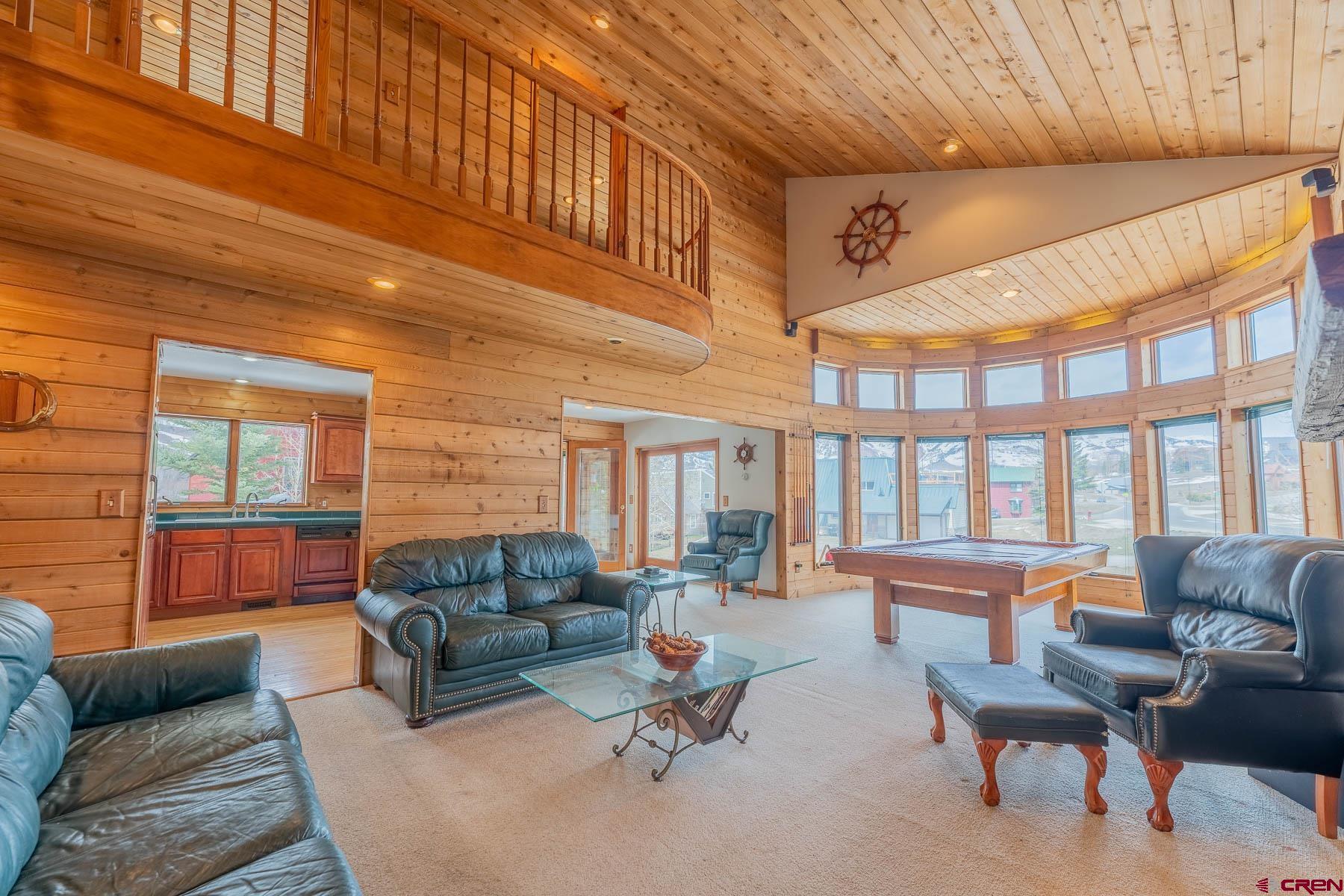10 Arrowhead Circle Crested Butte, CO 81225 - Photo 4 of 33 a living room with furniture a fireplace and a large window