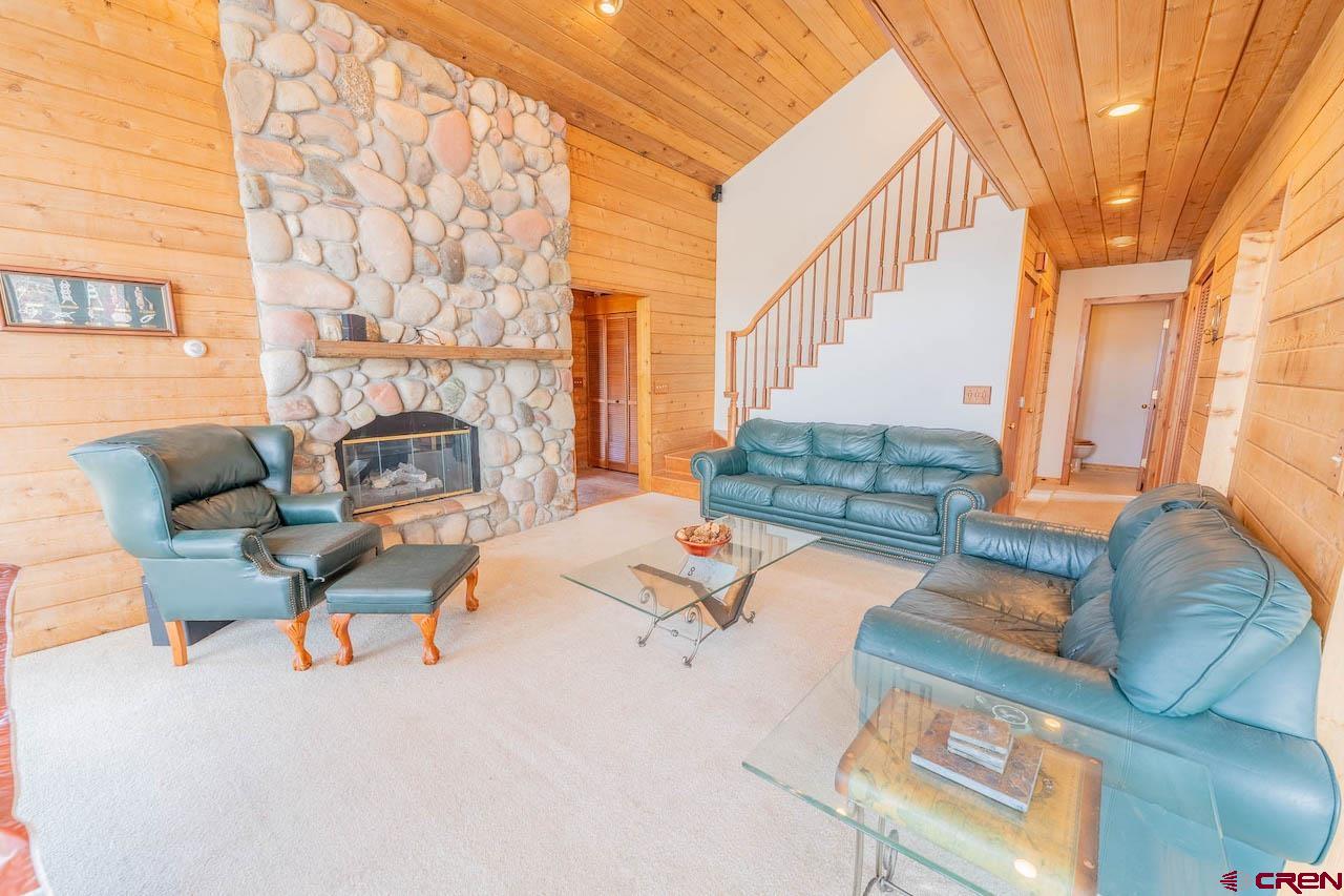 10 Arrowhead Circle Crested Butte, CO 81225 - Photo 9 of 33 a living room with furniture and a fireplace