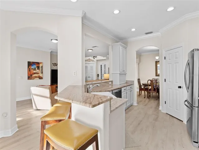 a kitchen with granite countertop white cabinets and a sink