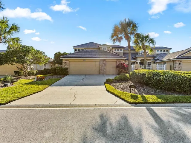 a view of a white house with a swimming pool and a yard